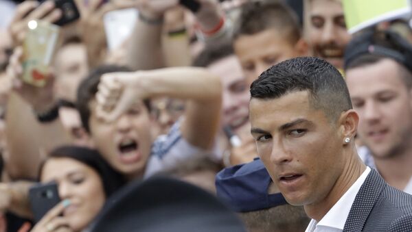 Portuguese ace Ronaldo passes among enthusiast fans as he arrives to undergo medical checks at the Juventus stadium in Turin, Italy, Monday, July 16, 2018 - Sputnik International