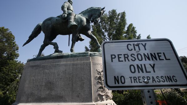 In this Monday, 6 August 2018 photo, a No Trespassing sign is displayed in front of a statue of Robert E. Lee in Charlottesville, Virginia, at the park that was the focus of the Unite the Right rally.  - Sputnik International