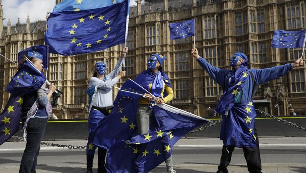 Pro-remain supporters of Britain staying in the EU, wear EU flag masks as they take part in an anti-Brexit protest outside the Houses of Parliament in London, Monday, Sept. 11, 2017. Lawmakers are due to vote late Monday or early Tuesday on the European Union (Withdrawal) Bill, which aims to convert around 12,000 EU laws and regulations into domestic statute on the day the country leaves the bloc in March 2019 - Sputnik International