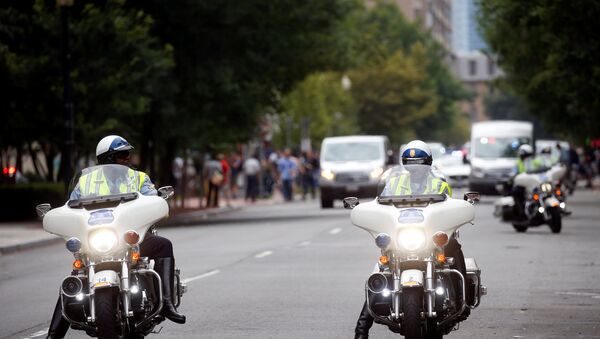 Police on motorcycles are pictured near a protest against the white nationalist-led Unite the Right rally held in front of the White House on the one-year anniversary of the white nationalist-led rally in Charlottesville, VA, in downtown Washington, U.S., August 12, 2018. - Sputnik International