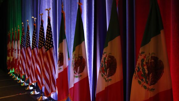 In this Aug. 16, 2017 file photo, the national flags of Canada, the U.S. and Mexico are lit by stage lights before a news conference, at the start of the North American Free Trade Agreement renegotiations in Washington - Sputnik International