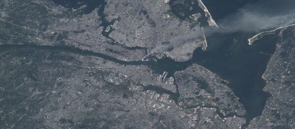 Visible from space, a smoke plume rises from the Manhattan area after two planes crashed into the towers of the World Trade Center. This photo was taken of metropolitan New York City (and other parts of New York as well as New Jersey) the morning of September 11, 2001. Visible from space, a smoke plume rises from the Manhattan area after two planes crashed into the towers of the World Trade Center. This photo was taken of metropolitan New York City (and other parts of New York as well as New Jersey) the morning of September 11, 2001. - Sputnik International
