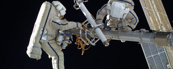 Two Russian cosmonauts, wearing space suits, Orlan-MK Two Russian cosmonauts, wearing space suits, Orlan-MK - Sputnik International