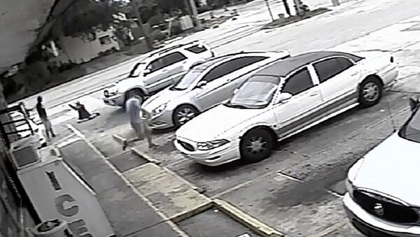 In this Thursday, July 19, 2018 image taken from surveillance video released by the Pinellas County Sheriff's Office, Markeis McGlockton, far left, is shot by Michael Drejka during an altercation in the parking lot of a convenience store in Clearwater, Fla. The family of McGlockton issued an appeal Tuesday, July 24, 2018, through an attorney for the public to put pressure on State Attorney Bernie McCabe to file charges against Drejka, a white man who fatally shot the black father of three last Thursday upon being pushed to the ground outside a convenience store. - Sputnik International