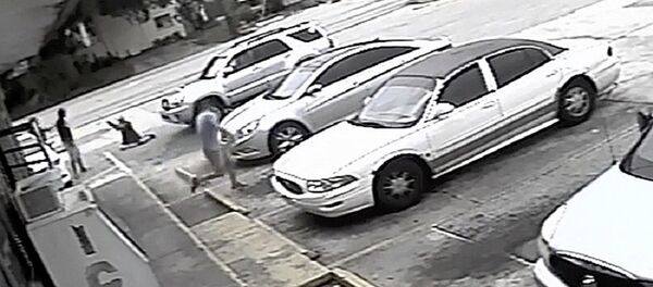 In this Thursday, July 19, 2018 image taken from surveillance video released by the Pinellas County Sheriff's Office, Markeis McGlockton, far left, is shot by Michael Drejka during an altercation in the parking lot of a convenience store in Clearwater, Fla. The family of McGlockton issued an appeal Tuesday, July 24, 2018, through an attorney for the public to put pressure on State Attorney Bernie McCabe to file charges against Drejka, a white man who fatally shot the black father of three last Thursday upon being pushed to the ground outside a convenience store. In this Thursday, July 19, 2018 image taken from surveillance video released by the Pinellas County Sheriff's Office, Markeis McGlockton, far left, is shot by Michael Drejka during an altercation in the parking lot of a convenience store in Clearwater, Fla. The family of McGlockton issued an appeal Tuesday, July 24, 2018, through an attorney for the public to put pressure on State Attorney Bernie McCabe to file charges against Drejka, a white man who fatally shot the black father of three last Thursday upon being pushed to the ground outside a convenience store. - Sputnik International