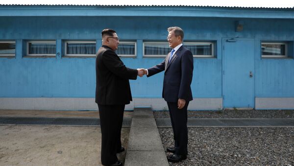 (FILES) This file photo taken on April 27, 2018 shows North Korea's leader Kim Jong Un (L) shaking hands with South Korea's President Moon Jae-in (R) at the Military Demarcation Line that divides their countries ahead of their summit at the truce village of Panmunjom - Sputnik International