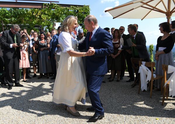 Russian President Vladimir Putin, right, congratulates Austrian Foreign Minister Karin Kneissl as he attends the wedding of Kneissl with with Austrian businessman Wolfgang Meilinger in Gamlitz, southern Austria, Saturday, Aug. 18, 2018. Russian President Vladimir Putin, right, congratulates Austrian Foreign Minister Karin Kneissl as he attends the wedding of Kneissl with with Austrian businessman Wolfgang Meilinger in Gamlitz, southern Austria, Saturday, Aug. 18, 2018. - Sputnik International