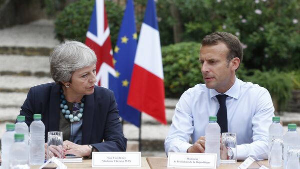 French President Emmanuel Macron, right, meets with British Prime Minister Theresa May to discuss Brexit issues at the Fort de Bregancon in Bornes-les-Mimosas, southern France, Friday Aug. 3, 2018 - Sputnik International