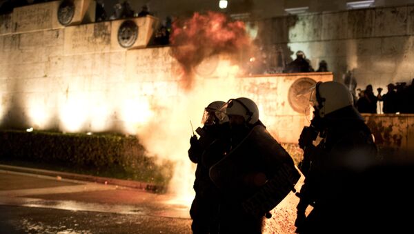 A petrol bomb thrown by protesters explodes behind riot police during a rally outside the Greek Parliament in Athens, Monday, Jan. 15, 2018. Greek lawmakers, eying the end of eight years of bailout programs, approved more painful austerity measures late Monday, as strikes and mass protests brought much of Athens to a standstill - Sputnik International