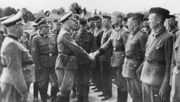 This 1942 photo provided by the the public prosecutor's office in Hamburg via the United States Holocaust Memorial Museum, shows Heinrich Himmler, center left, shaking hands with new guard recruits at the Trawniki concentration camp in Nazi occupied Poland. - Sputnik International