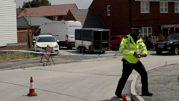 A white van with a trailer is allowed to pass through a police cordon as it drives around the corner before parking outside a property shielded from view that police have been guarding in Amesbury, England, Thursday, July 5, 2018. British officials were seeking clues Thursday in the rush to understand how two Britons were exposed to the military-grade nerve agent Novichok - Sputnik International