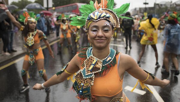 Dancers perform during the Notting Hill Carnival Family Day at the annual carnival event in London, Sunday Aug. 26, 2018. Wet and windy weather is disrupting this summer's Notting Hill Carnival - Sputnik International