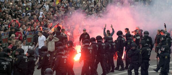 Protesters light fireworks during a far-right demonstration in Chemnitz, Germany, Monday, Aug. 27, 2018 after a man has died and two others were injured in an altercation between several people of various nationalities in the eastern German city of Chemnitz on Sunday Protesters light fireworks during a far-right demonstration in Chemnitz, Germany, Monday, Aug. 27, 2018 after a man has died and two others were injured in an altercation between several people of various nationalities in the eastern German city of Chemnitz on Sunday - Sputnik International