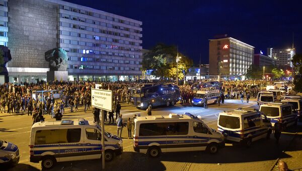 Police vehicles are seen as right-wing supporters protest after a German man was stabbed last weekend in Chemnitz, Germany, August 27, 2018 - Sputnik International