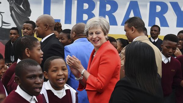 British Prime Minister Theresa May meets pupils during a visit at the the ID Mkhize High School in Gugulethu, Cape Town, South Africa, Tuesday, Aug. 28, 2018. Theresa May has started a three-nation visit to Africa where she is to meet South African President Cyril Ramaphosa - Sputnik International