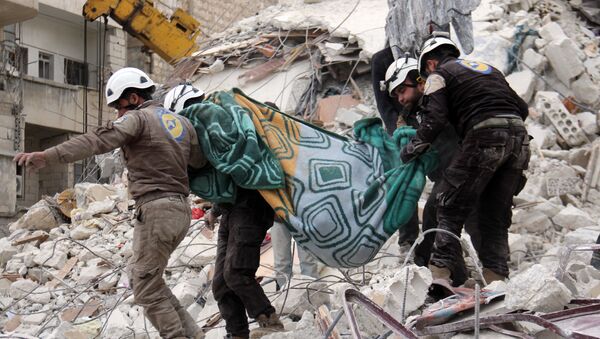 Syrian civil defence volunteers, known as the White Helmets, carry a body retrieved from the rubble following reported government airstrike on the Syrian town of Ariha, in the northwestern province of Idlib, on February 27, 2017 - Sputnik International