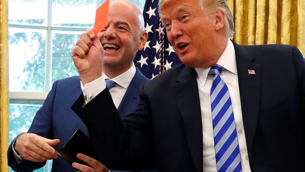 U.S. President Donald Trump holds red card as he meets with FIFA President Infantino in the Oval Office of the White House in Washington - Sputnik International