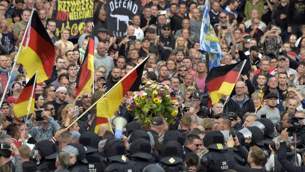 Protesters carry a wreath as they gather for a far-right protest in Chemnitz, Germany, Monday, Aug. 27, 2018 after a man has died and two others were injured in an altercation between several people of various nationalities in the eastern German city of Chemnitz on Sunday - Sputnik International