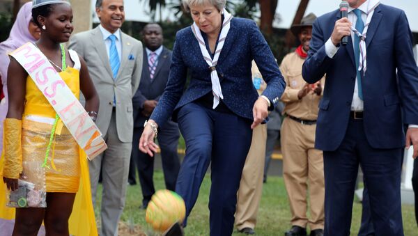 Britain's Prime Minister Theresa May kicks a ball made of recycled plastic as former Norwegian politician and Executive Director of the UN Environment Programme Erik Solheim looks on during her visit to the United Nations complex within Gigiri in Nairobi, Kenya August 30, 2018. - Sputnik International