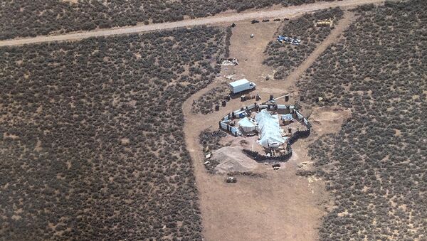 This Friday, Aug. 3, 2018, aerial photo released by Taos County Sheriff's Office shows a rural compound during an unsuccessful search for a missing 3-year-old boy in Amalia, N.M. Law enforcement officers searching the compound for the missing child didn't locate him but found 11 other children in filthy conditions and hardly any food, a sheriff said Saturday. - Sputnik International