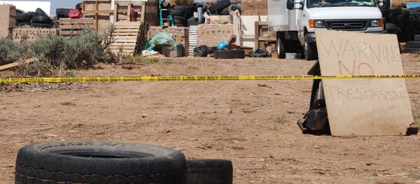 Police tape restricts access to a disheveled living compound in Amalia, N.M., on Tuesday, Aug. 7, 2018. Police tape restricts access to a disheveled living compound in Amalia, N.M., on Tuesday, Aug. 7, 2018. - Sputnik International