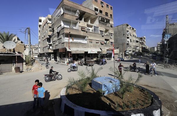 In a picture taken through a bus window, people drive their motorcycles in Damascus, Syria, Monday, Aug. 13, 2018 In a picture taken through a bus window, people drive their motorcycles in Damascus, Syria, Monday, Aug. 13, 2018 - Sputnik International