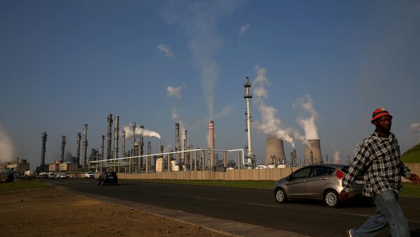 A man walks past South African petrochemical company Sasol's synthetic fuel plant in Secunda, north of Johannesburg (File) - Sputnik International