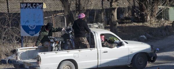 A group of men, not specified which group of rebels, drive into an abandoned UN post at Syria's Quneitra border crossing between Syria and the Israeli-controlled Golan Heights, seen from the Israeli-controlled Golan Heights, Monday, Nov. 28, 2016. A group of men, not specified which group of rebels, drive into an abandoned UN post at Syria's Quneitra border crossing between Syria and the Israeli-controlled Golan Heights, seen from the Israeli-controlled Golan Heights, Monday, Nov. 28, 2016. - Sputnik International