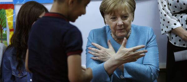 German Chancellor Angela Merkel, right, sits inside a classroom, as she speaks with Lebanese and Syrian displaced students where they studying together, during her visit to a Lebanese public school, in Beirut, Lebanon, Friday, June 22, 2018. Merkel is visiting Jordan and Lebanon, both neighbors of war-torn Syria, amid an escalating domestic row over migration German Chancellor Angela Merkel, right, sits inside a classroom, as she speaks with Lebanese and Syrian displaced students where they studying together, during her visit to a Lebanese public school, in Beirut, Lebanon, Friday, June 22, 2018. Merkel is visiting Jordan and Lebanon, both neighbors of war-torn Syria, amid an escalating domestic row over migration - Sputnik International