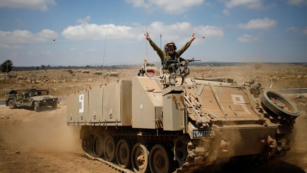 An Israeli soldier rides an armoured vehicle during a army drill after the visit of Israeli Defence Minister Avigdor Lieberman in the Israeli-occupied Golan Heights, Israel August 7, 2018 - Sputnik International
