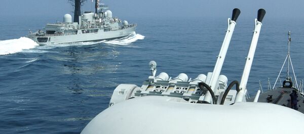 British Royal Navy Guided missile Destroyer HMS Exeter (L) passes a Chinese naval vessel, off the eastern port city of Qingdao. File photo - Sputnik International
