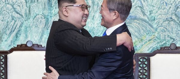 North Korean leader Kim Jong Un, left, and South Korean President Moon Jae-in embrace each other after signing on a joint statement at the border village of Panmunjom in the Demilitarized Zone, South Korea, Friday, April 27, 2018. - Sputnik International