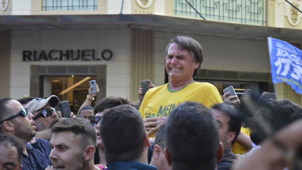 Presidential candidate Jair Bolsonaro grimaces right after being stabbed in the stomach during a campaign rally in Juiz de Fora, Brazil, Thursday, Sept. 6, 2018 - Sputnik International