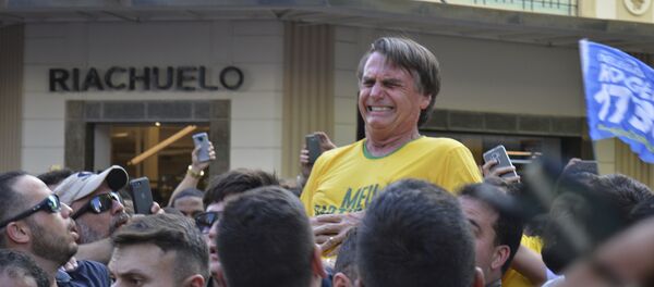 Presidential candidate Jair Bolsonaro grimaces right after being stabbed in the stomach during a campaign rally in Juiz de Fora, Brazil, Thursday, Sept. 6, 2018 - Sputnik International