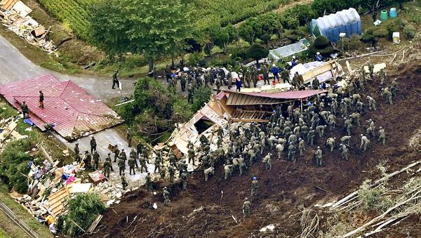 Members of the Japan Self-Defense Forces (JSDF) search for survivors from a house damaged by a landslide caused by an earthquake in Atsuma town, Hokkaido, northern Japan, in this photo taken by Kyodo September 7, 2018 - Sputnik International