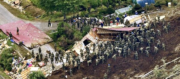 Members of the Japan Self-Defense Forces (JSDF) search for survivors from a house damaged by a landslide caused by an earthquake in Atsuma town, Hokkaido, northern Japan, in this photo taken by Kyodo September 7, 2018 - Sputnik International