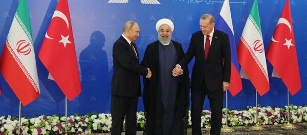 Russian President Vladimir Putin, Iranian President Hassan Rouhani, and Turkish President Recep Tayyip Erdogan during trilateral talks in Tehran. - Sputnik International