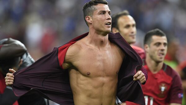 Portugal's forward Cristiano Ronaldo takes off his jacket after beating France 1-0 in the Euro 2016 final football match between France and Portugal at the Stade de France in Saint-Denis, north of Paris, on July 10, 2016. - Sputnik International