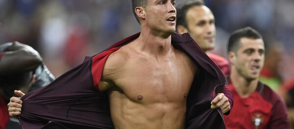 Portugal's forward Cristiano Ronaldo takes off his jacket after beating France 1-0 in the Euro 2016 final football match between France and Portugal at the Stade de France in Saint-Denis, north of Paris, on July 10, 2016. - Sputnik International
