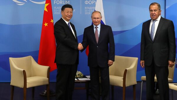 September 11, 2018. President Vladimir Putin and Chinese President Xi Jinping, left, during a meeting on the sidelines of the 4th Eastern Economic Forum at the Far Eastern Federal University on the Russky Island. Right: Foreign Minister Sergei Lavrov - Sputnik International