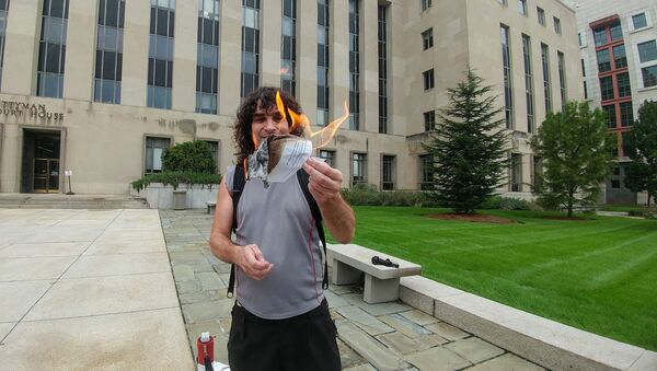 DC Indymedia reporter Luke Kuhn was served a subpoena September 5 informing him that he was “commanded” to testify before a federal grand jury. Kuhn burned a copy of the subpoena outside of the courthouse as he refused to testify. - Sputnik International