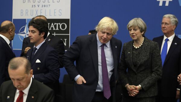 British Prime Minister Theresa May and British Foreign Minister Boris Johnson look toward Turkish President Recep Tayyip Erdogan, right, as they participate in a working dinner meeting at the NATO headquarters during a NATO summit of heads of state and government in Brussels on Thursday, May 25, 2017 - Sputnik International