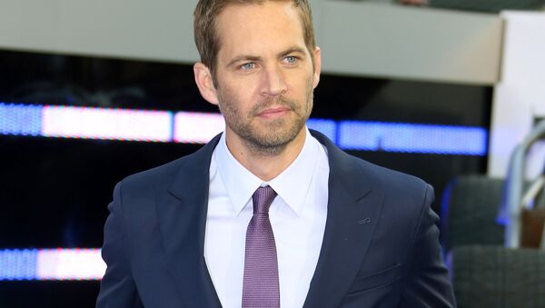 In this May 7, 2013 file photo, actor Paul Walker arrives for the World Premiere of Fast & Furious 6, in central London. Wiz Khalifa and Charlie Puth’s song, “See You Again,” a tribute to Walker, hit No.1 on Billboard Hot 100’s chart this week. It is featured on the “Furious 7” soundtrack, which debuted at No.1 on Billboard’s 200 albums chart this week - Sputnik International