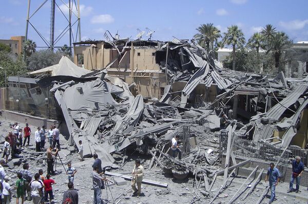 In this photo taken on a government-organized tour, media film damage from what officials said was a NATO airstrike at a hotel, in the capital Tripoli, Libya Thursday, June 16, 2011, while what officials described as a telecommunications tower is seen at left In this photo taken on a government-organized tour, media film damage from what officials said was a NATO airstrike at a hotel, in the capital Tripoli, Libya Thursday, June 16, 2011, while what officials described as a telecommunications tower is seen at left - Sputnik International