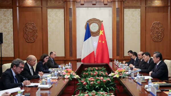 China's Foreign Minister Wang Yi meets with France's Foreign Affairs Minister Jean-Yves Le Drian at Diaoyutai State Guesthouse in Beijing, China September 13, 2018 - Sputnik International