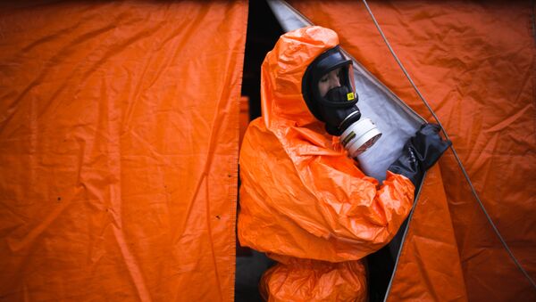 A German emergency worker looks out of a tent for decontamination during a joint anti-terror exercise of German authorities in Berlin, Wednesday, Oct. 11, 2017. - Sputnik International