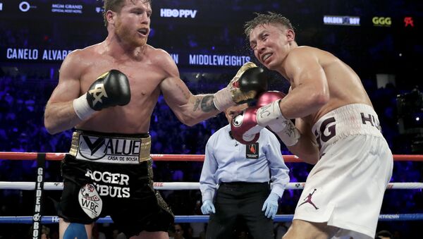 Saul Alvarez (black trunks) lands a punch on the chin of Gennady Golovkin during Saturday's fight in Las Vegas - Sputnik International