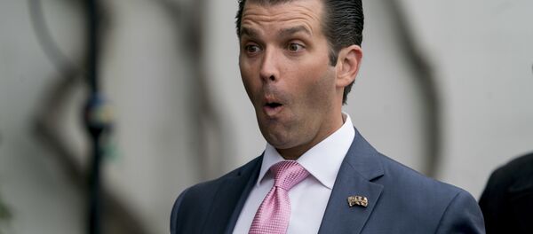 Donald Trump Jr., the son of President Donald Trump, makes a face at one of his children during the annual White House Easter Egg Roll on the South Lawn of the White House in Washington, Monday, April 2, 2018 - Sputnik International