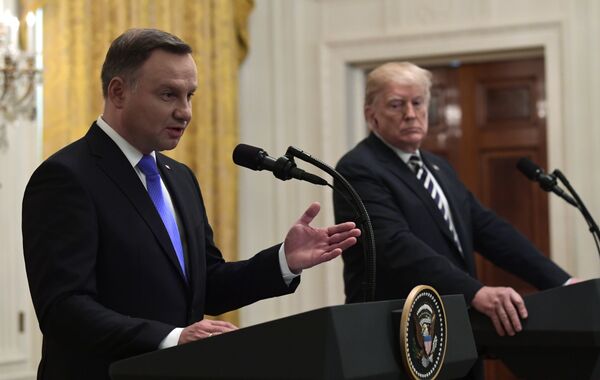 President Donald Trump, right, listens as Polish President Andrzej Duda, left, speaks during a joint news conference in the East Room of the White House in Washington, Tuesday, Sept. 18, 2018 - Sputnik International