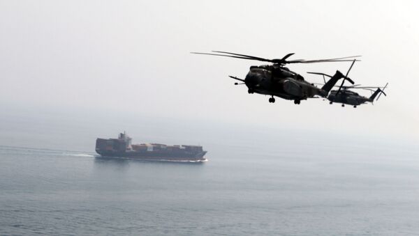 U.S. Navy MH-53E Sea Dragon helicopters are seen making their way to an exercise area as they take part in a U.S. and U.K. Mine Countermeasures Exercise (MCMEX) taking place at the Arabian Sea, as a cargo ship is seen sailing towards Straits of Harmoz, September 10, 2018 - Sputnik International